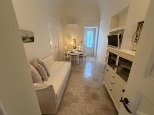 a living room with a white couch and a table at Dimael Mansion in Fira