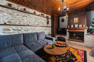 a living room with a couch and a fireplace at Villa Ploski in Ploski
