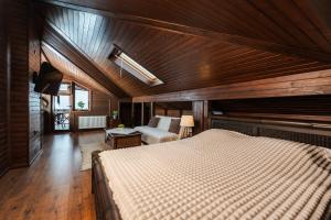 a bedroom with a large bed in a wooden room at Villa Ploski in Ploski +92 photos