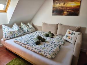 a couch with stuffed animals on it in a living room at Salvia Guesthouse Balatonfüred in Balatonfüred