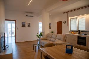 a living room with a couch and a table at MD Beach Home in Roseto degli Abruzzi +21 photos