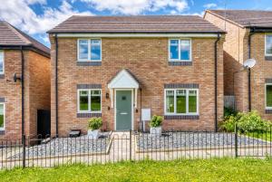 a brick house with a green door at CHERRYTREES Beautiful 5 Bedrooms, Sleeps 9, 3 Bathrooms, Parking, Ideal for Groups and Work Stays in Corby