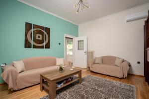 a living room with two couches and a table at Karydeones Living in Kleidoniá
