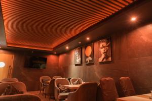 a restaurant with tables and chairs in a room at Raj Regent Manarcadu in Kanjirapalli