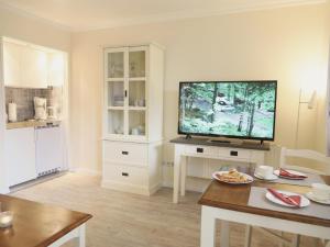a living room with a large flat screen tv at Fischerweg-39-Whg-2-Amrum in Westerland