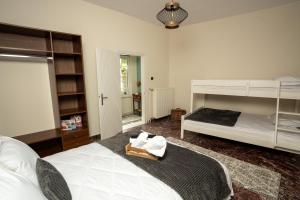a bedroom with a bed and a bunk bed at Karydeones Living in Kleidoniá