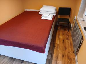 a bedroom with a bed with towels on it at Forrent-ee in Pärnu +13 photos