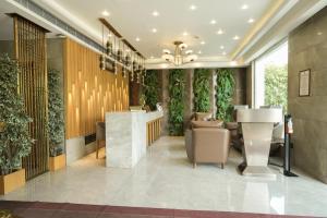 a lobby of a hotel with plants on the walls at Raj Regent Manarcadu in Kanjirapalli