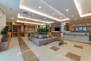 a large living room with a couch in the middle at Sidra Serviced Apartments - سدرا للشقق المخدومة in Al Khobar