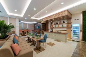 a lobby with a couch and a table and chairs at Sidra Serviced Apartments - سدرا للشقق المخدومة in Al Khobar