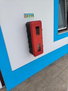 a red object is on the side of a wall at A Quinta in Vila Nova de Milfontes +36 photos