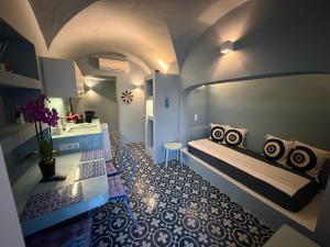 a room with two beds and a sink in it at Dimael Mansion in Fira