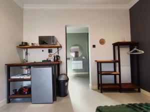 a living room with a refrigerator and a mirror at Unit 8 Dinas Accommodation Oranjemund in Oranjemund
