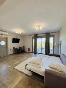 a large bedroom with a large bed and a couch at Danita Apartments 3 in Paleros