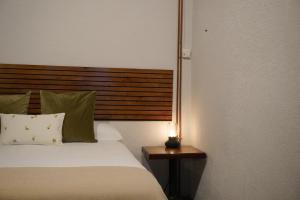 a bedroom with a bed with a lamp on a table at Loft Pedreña Studio in Pedreña +5 photos