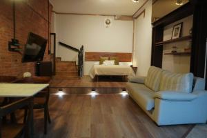 a living room with a couch and a bed at Loft Pedreña Studio in Pedreña