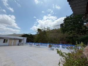 a parking lot with a fence and a building at Hotel HillView, Junagadh in Junagadh