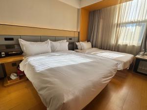 a large white bed in a hotel room at JI Hotel Beijing Happy Valley in Beijing +16 photos