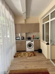 a kitchen with a washer and dryer in a room at АпартаментРадугаВест1 in Koshkolʼ