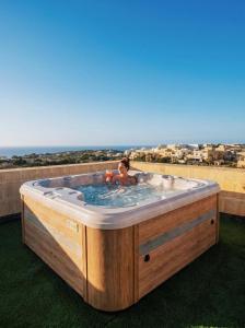 a child in a jacuzzi tub on a roof at Peaceful Home with Private Pool and Rooftop Jacuzzi in Xagħra