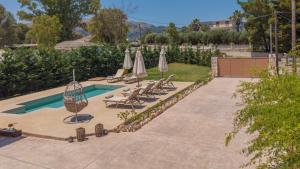 a swimming pool with lounge chairs and umbrellas at Villa Nicoldia with private pool near Laganas in Laganas