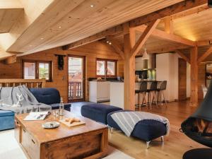 a living room with a couch and a table at Chalet 4★, 15 pers, La Clusaz, sauna, centre village, 7 chambres - FR-1-304-177 in La Clusaz +18 photos