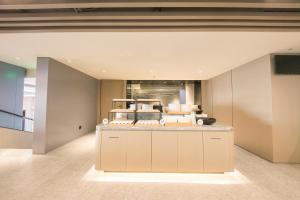 a kitchen with a counter in the middle of a room at JI Hotel Beijing Happy Valley in Beijing
