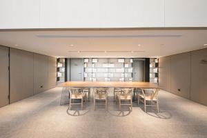 a conference room with a long table and chairs at JI Hotel Beijing Happy Valley in Beijing