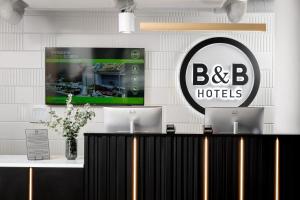 a bar in a hotel with two computers on it at B&B HOTEL Kalisz Centrum in Kalisz