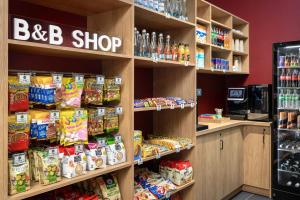 a store aisle with shelves filled with food at B&B HOTEL Kalisz Centrum in Kalisz