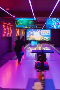 a man is walking down a bowling alley at Hotel Tarnovia in Tarnów
