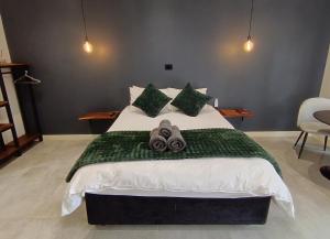 a bedroom with a large bed with towels on it at Unit 9 Dinas Accommodation Oranjemund in Oranjemund
