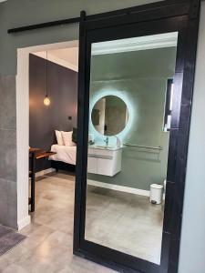 a mirror in a room with a sink and a bed at Unit 9 Dinas Accommodation Oranjemund in Oranjemund