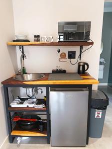 a kitchen with a counter with a sink and a microwave at Unit 9 Dinas Accommodation Oranjemund in Oranjemund +11 photos