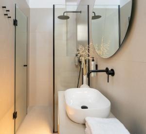 a bathroom with a sink and a mirror at Asterry Suites in Kimolos