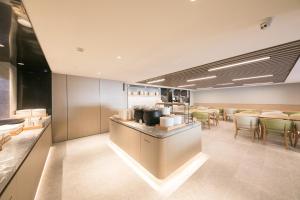 a restaurant with a bar with chairs and tables at JI Hotel Beijing Happy Valley in Beijing