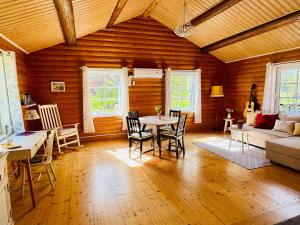 a living room with a table and a couch at Haus Sommerlycka in Fågelfors