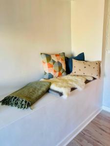 a grouping of pillows on a couch in a room at Haus Sommerlycka in Fågelfors