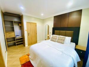 a bedroom with a large white bed and wooden cabinets at One Bedroom, Double bed and one sofa bed in Iseri