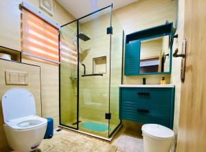 a bathroom with a toilet and a glass shower at One Bedroom, Double bed and one sofa bed in Iseri +10 photos