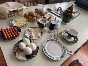 a table with plates of food and eggs on it at Abelyans Fam Hotel in Alaverdi