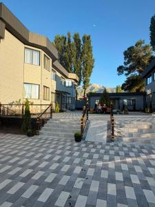 a building with a patio and stairs in front of it at Kol-Ukok Hotel in Bol'shevik