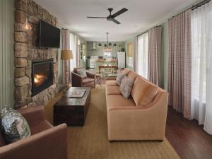 a living room with a couch and a fireplace at Hidden Pond Resort in Kennebunkport