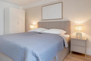 a bedroom with a blue bed with two pillows at Baltic Studio No 5 in Scharbeutz