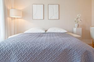 a bedroom with a large bed with two pillows at Baltic Studio No 5 in Scharbeutz +18 photos