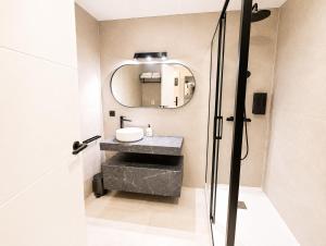 a bathroom with a sink and a mirror at AH Rentals in Vinarós +43 photos