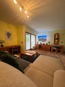 a living room with a couch and a table at Ferienwohnung Hunsrückblick in Thalfang