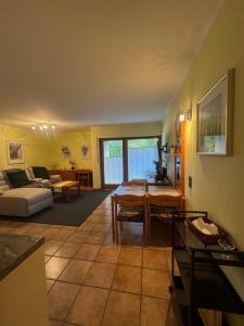 a living room with a couch and a table at Ferienwohnung Hunsrückblick in Thalfang