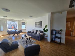 a living room with a couch and a table at Ferienwohnung Küstennah in Großenwiehe