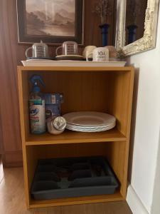 a wooden shelf with plates and dishes on it at Casa Maya with private parking in Oradea +80 photos